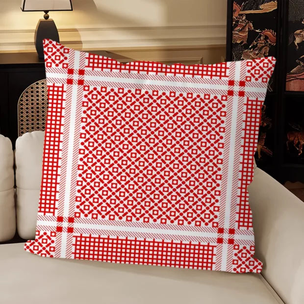 Housse de coussin rouge et écru avec réseau de losanges et motifs en rosace