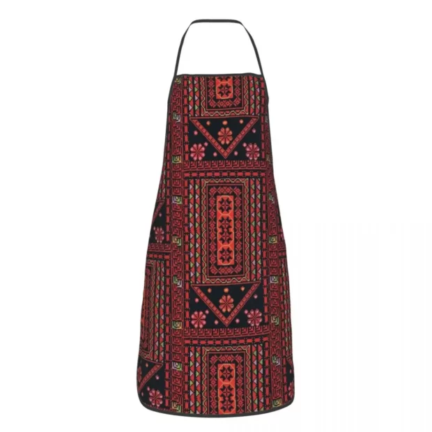 Tablier de cuisine à décor géométrique et floral inspiré du tatreez palestinien.
