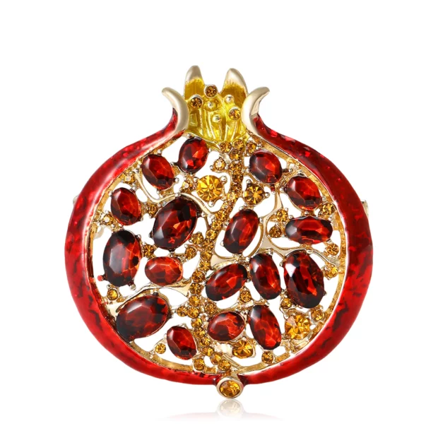Broche dorée en forme de grenade ouverte, décorée de strass rouges